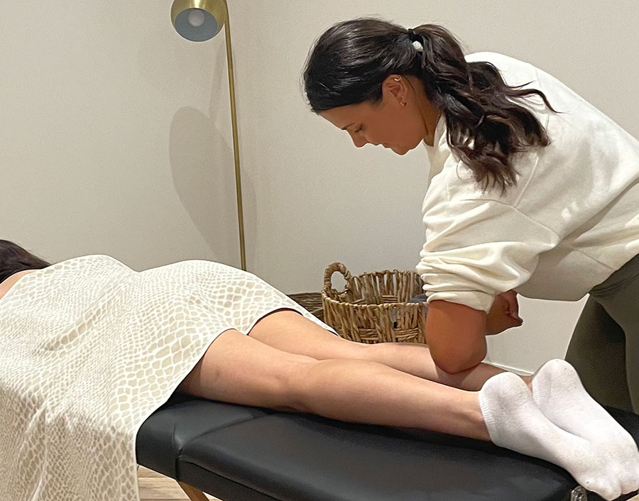 Hands-on soft tissue work on a client's lower leg